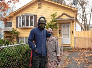 Sellou Coly stands in front of the home she is the land lord of in Springfield with her son, Ahmed Diaite, who rents one of the apartments.