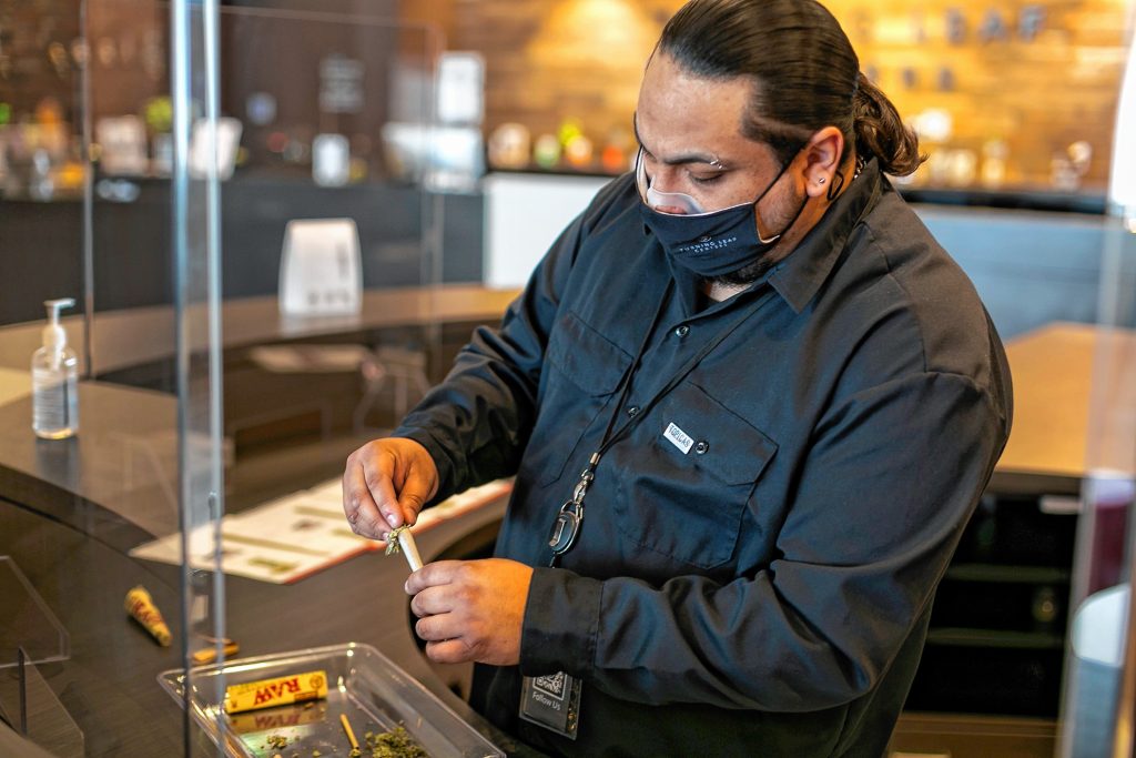 Steven Robles, of Northampton, packs a prerolled cone during a joint-rolling demonstration April 18  at Turning Leaf Centers dispensary in Northampton.