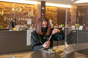 Turning Leaf Centers Marketing and Outreach Coordinator Nicole Desjardins, of Easthampton, packs a prerolled cone during a joint-rolling demonstration April 18 at the dispensary  in Northampton.