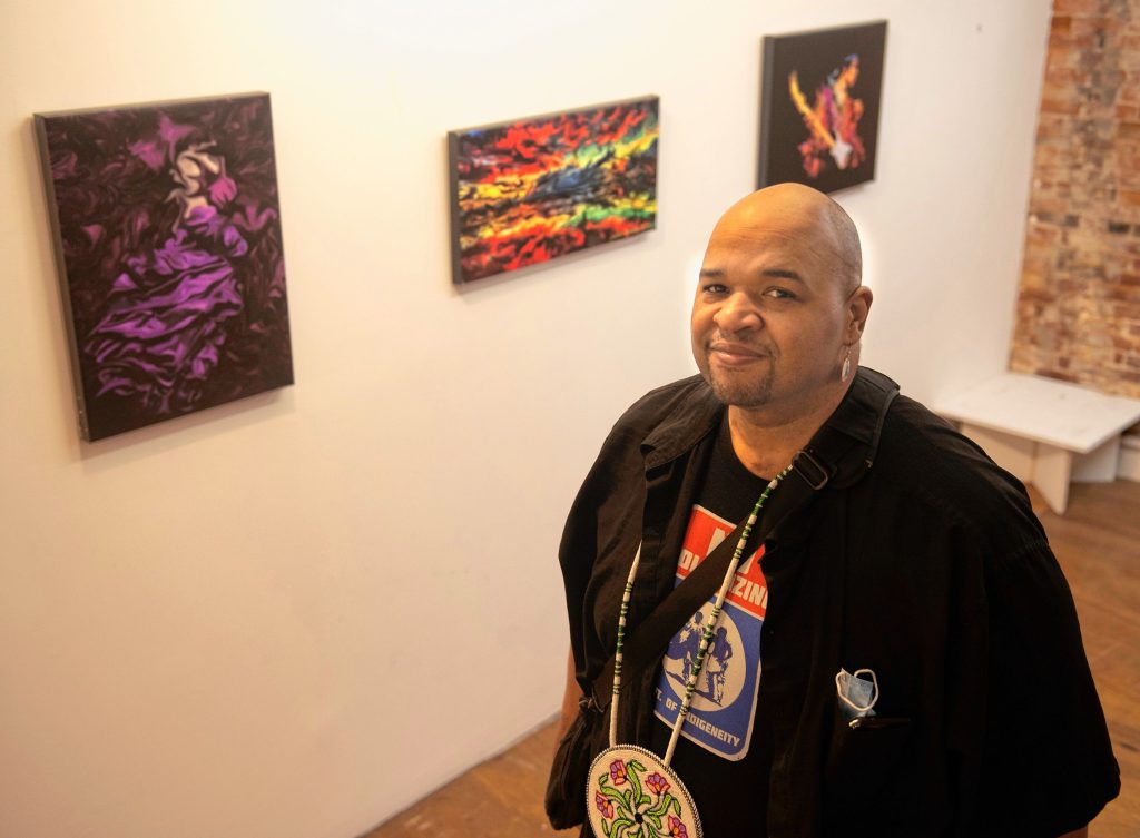 Justin Beatty, a Hadley artist and pow wow singer,  talks about his art work going up in the gallery Artesana owned by Carlos Pena in Holyoke. Beatty thinks the ArtsHub will help artists connect and serve as a “functional space for people to engage in these sorts of things. Art school didn’t teach you the business side.”