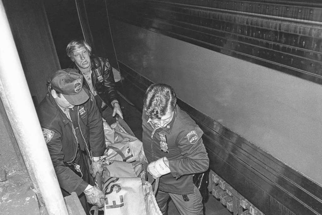 “Sad Ending,” 1978 photo by Jill Freedman of New York police officers carrying the body of a homeless man who had been sleeping next to subway tracks and died when he rolled onto the third rail. 