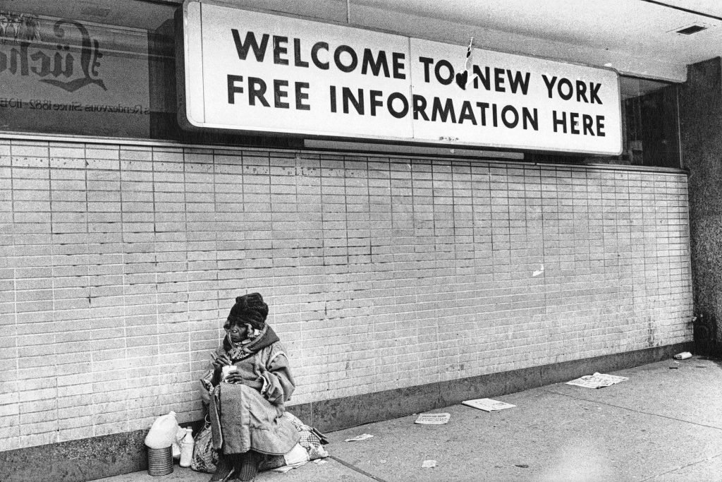“Welcome to New York,” a 1976 photo by Jill Freedman of a homeless woman in Times Square in Manhattan.