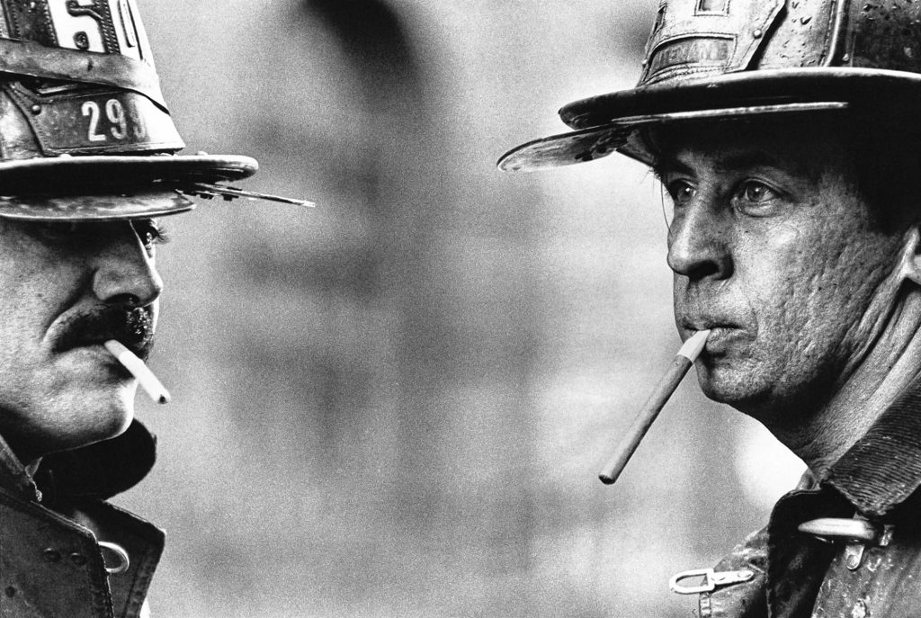 “Smoking Firefighters,” photo circa 1976 by Jill Freedman.