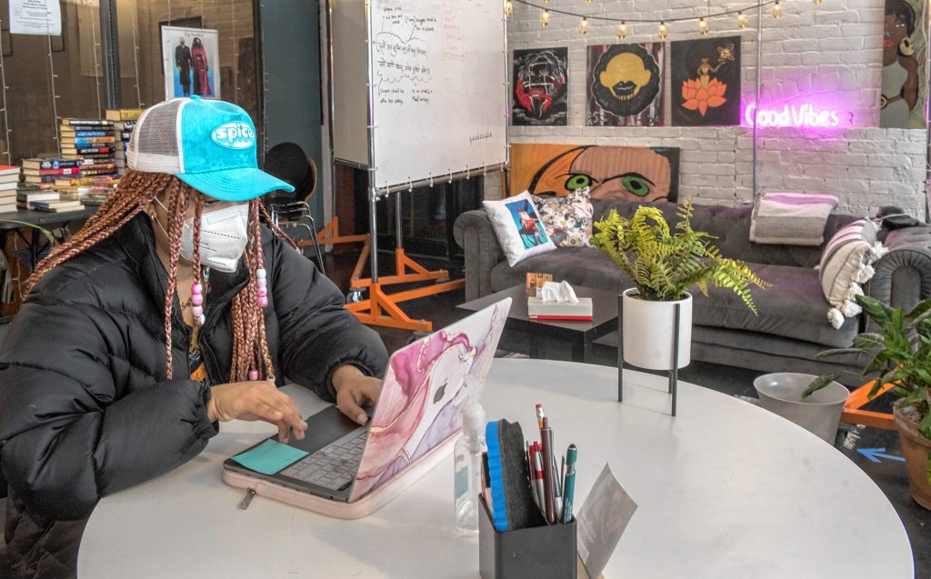 Sofia Meadows, a senior at the University of Massachusetts Amherst, volunteers at The Ethnic Study CoWork Cafe & Bookstore in Springfield on Friday, Feb. 11. The Ethnic Study, started by Stephany Marryshow and Simbrit Paskins, features works by local artists.