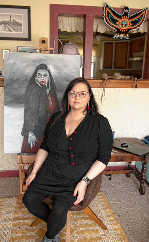 Nayana LaFond at home in Athol with her painting of Littlefox Steeprock, a survivor of domestic violence and now an advocate for the MMIW movement.