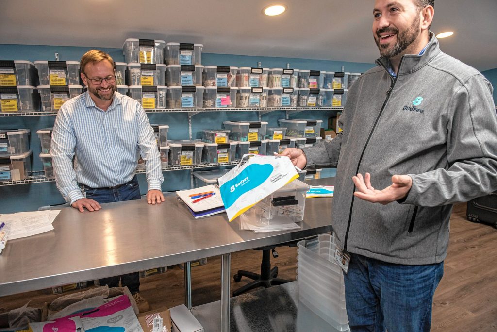 Budzee CEO Kevin Perrier, left, and COO Volkan Polatol talk about the child-resistant pouches used in their cannabis delivery business during an interview in the vault of the firm's warehouse in Easthampton on Friday, April 8, 2022.