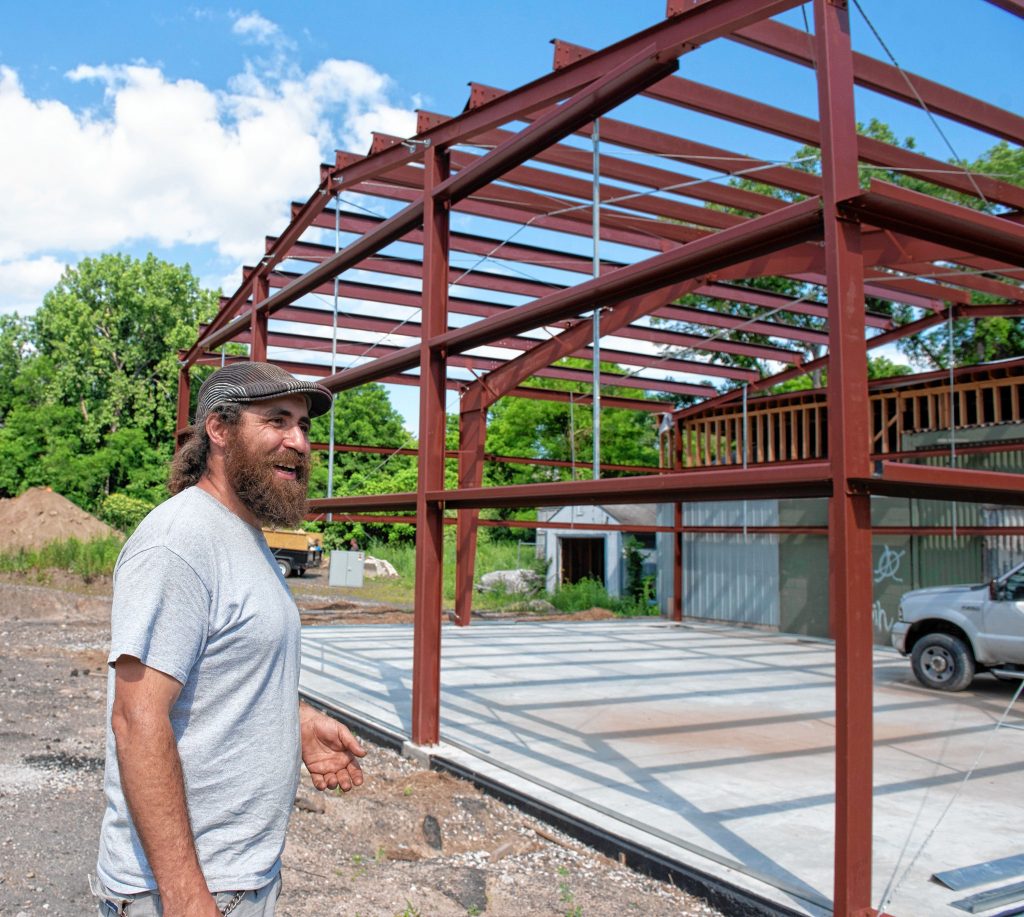 Ilya Tunitskiy, owner of Gan Or Cultivation, stands at the structure he is building off Damon Rd. in Northampton.