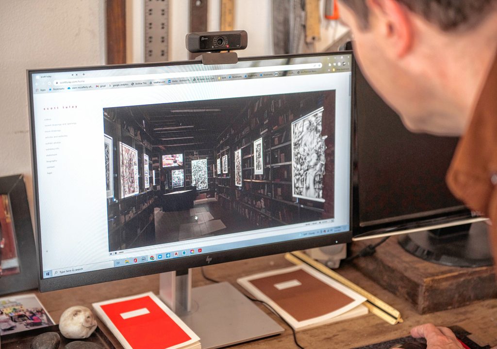 Northampton artist and architect Scott Tulay cues up a virtual visit of his show of drawings in the event space, an historic bookstore, of an exhibit in Venice, Italy. 
