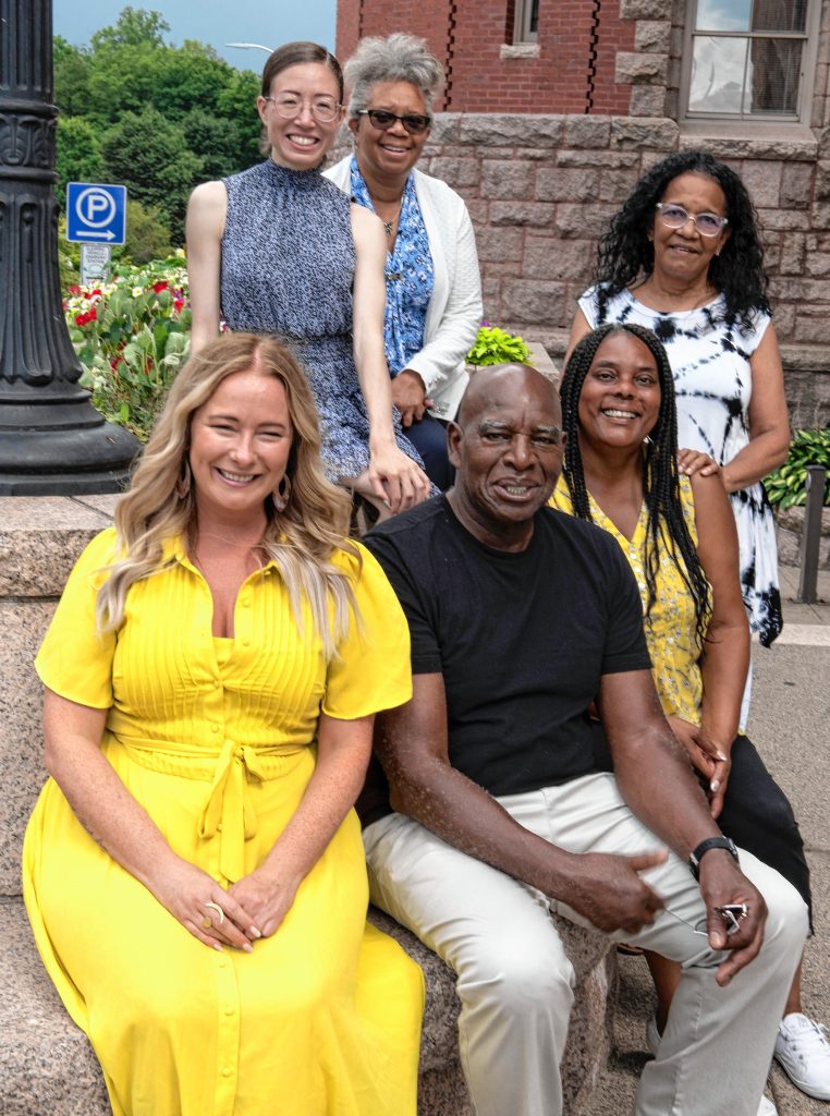 front left, Michele Miller, chair of the African Heritage Reparation Assembly, back left, Alexis Reed, a member of the AHRA, Pamela Nolan Young, director of DEI, Debora Bridges, a member of AHRA, Jennifer Moyston, assistant director of DEI, and  Irv Rhodes, a member of AHRA.