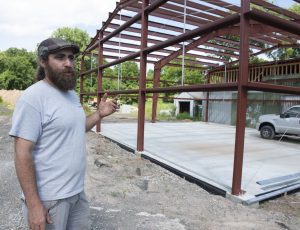 Ilya Tunitskiy, owner of Gan Or Cultivation, stands at the structure he is building off Damon Rd. in Northampton.