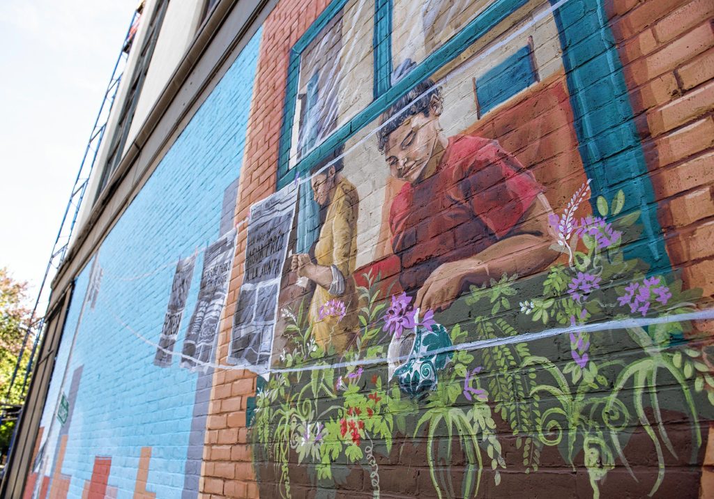 A mural by Colectivo Morivivi about the  Puerto Rican Daispora  showing a family making a home here on Hampden street in Springfield.