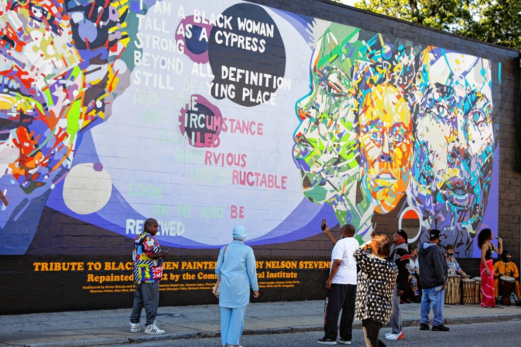 The Tribute to Black Women mural, originally created by her father Nelson Stevens in 1974, that was recreated by Common Wealth Murals and the Community Mural Institute and is now on view at 38 Catherine Street in Springfield.
