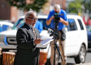 Clyde Santana speaks Saturday afternoon during the commemoration ceremony of The Wall of Black Music mural, originally created by Nelson Stevens with Santana as his student, that was recreated by Common Wealth Murals and the Community Mural Institute and is now on view at 1 Montrose Street in Springfield.