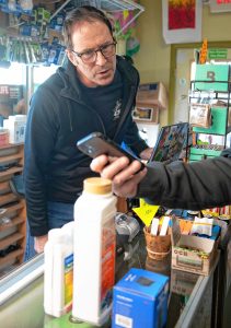 Doug Andrews, owner of Here We Grow in Hadley works with a customer as they talk about different products used for growing plants.