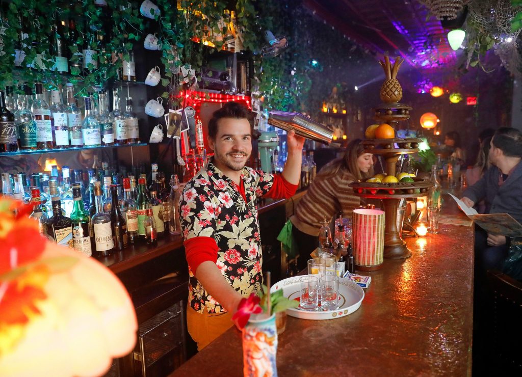 Ned King, owner of Gigantic in Easthampton, shakes up a cocktail Saturday night during the bar’s current tropical themed pop up, “Escape the Northeast.”