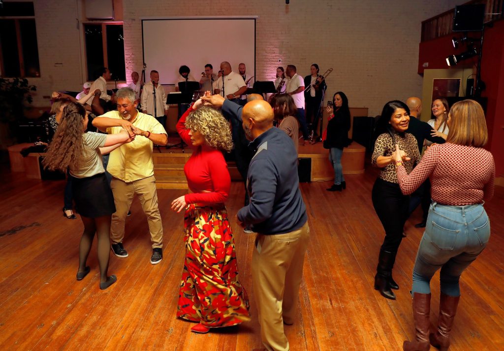 Dancers take to the floor as the Salsa Train Orquestra performs Friday night at Marigold Theater in Easthampton.