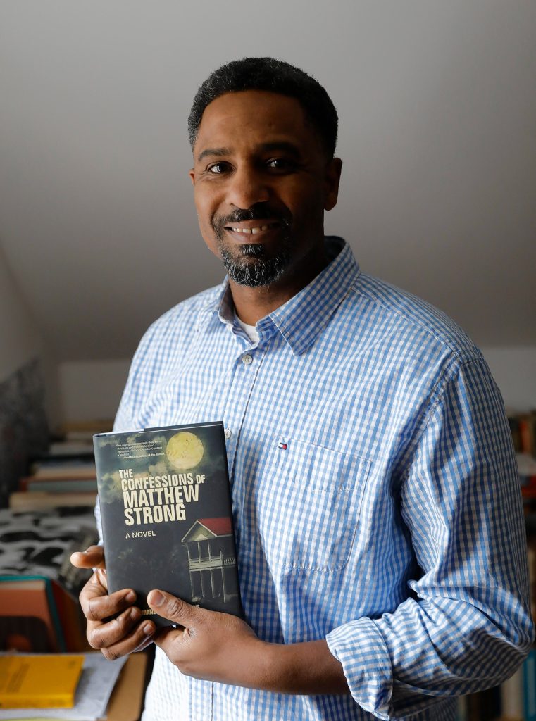 Ousmane Power-Greene with his debut novel, “The Confessions of Matthew Strong,” at the David Ruggles Center in Florence, where he’s often presented talks on Black history.