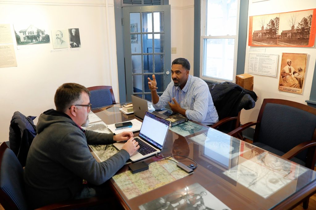 Ousmane Power-Greene, right, and independent educator Michael Lawrence-Riddell have a discussion in the Sojourner Truth room at the David Ruggles Center in Florence.