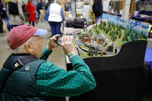 Toby Pelts photographs an exhibit during the annual Railroad Hobby Show produced by the Amherst Railway Society at the Eastern States Exposition grounds in West Springfield.