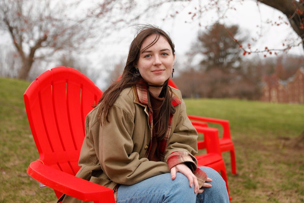 Elizabeth Mawrey, 20, who is a junior english major at UMass and president of the Cannabis Education Coalition, sits for a portrait Friday afternoon at the Orchard Hill section of campus in Amherst.